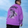 Model wearing a purple oversized sweatshirt with bold resilience graphic artwork on the back, styled outdoors.