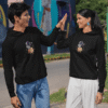 Man and woman wearing matching black astronaut hoodies giving a high-five outdoors
