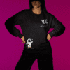 Dream Big Like The Universe Astronaut Sweatshirt – Leversi Black astronaut graphic sweatshirt worn by woman on purple background