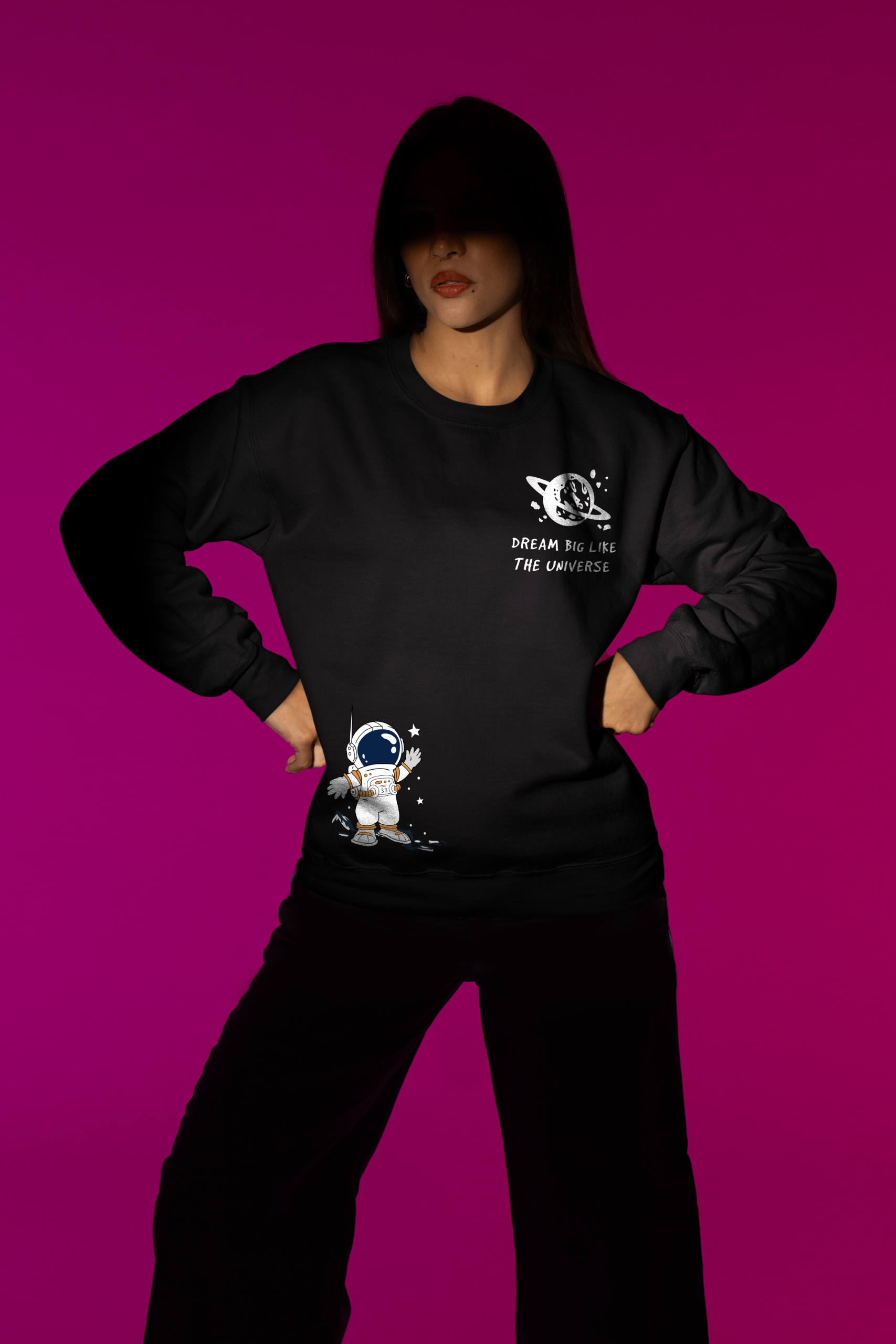 Dream Big Like The Universe Astronaut Sweatshirt – Leversi Black astronaut graphic sweatshirt worn by woman on purple background