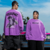 Two models wearing purple oversized resilience sweatshirts showing front and back designs, styled outdoors with a vintage car.