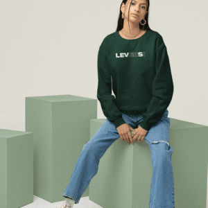 Female model wearing green Leversi logo sweatshirt styled with blue jeans