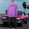 Model wearing a purple oversized resilience sweatshirt styled outdoors with a vintage car.