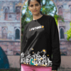 Woman in black “Future” graphic sweatshirt posing outdoors near architectural backdrop