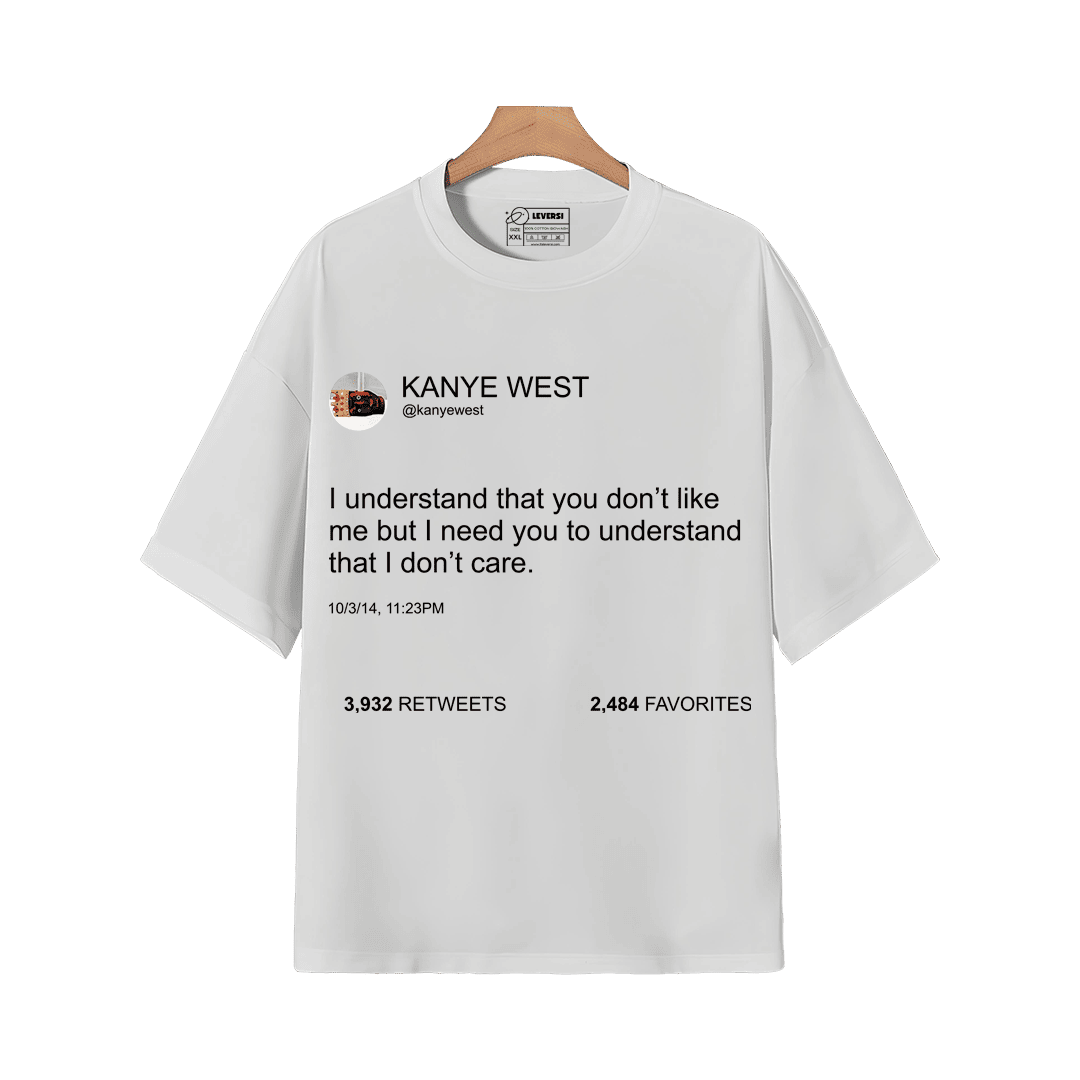 White graphic T-shirt featuring Kanye West tweet quote design on a wooden hanger.