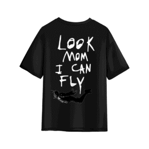 Black oversized T-shirt with large handwritten white text on the back reading “LOOK MOM I CAN FLY,” featuring a small black-and-white graphic of a flying figure near the bottom.