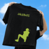 Person holding up a black T-shirt against a bright blue sky, featuring green “JACKBOYS” text and a neon-green silhouette graphic of a figure in motion.