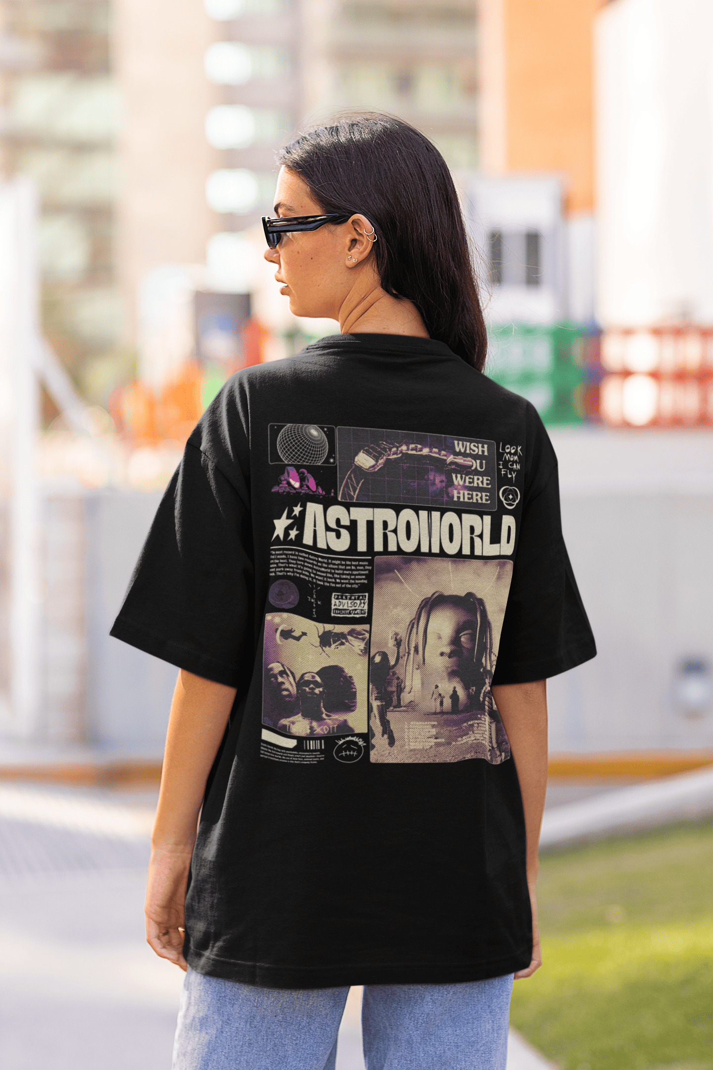 Woman wearing a black Astroworld graphic T-shirt with Travis Scott–inspired artwork on the back, standing outdoors.