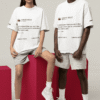 Man and woman wearing matching oversized white Kanye West tweet graphic T-shirts in a studio with pink blocks.