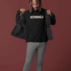 Man wearing a black Astroworld T-shirt and denim jacket posing in studio.