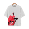White graphic T-shirt on a hanger featuring a bold red artistic face illustration.